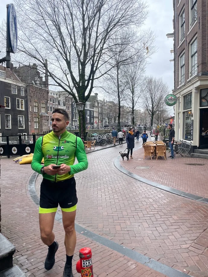 Standing on an Amsterdam street in green sports kit