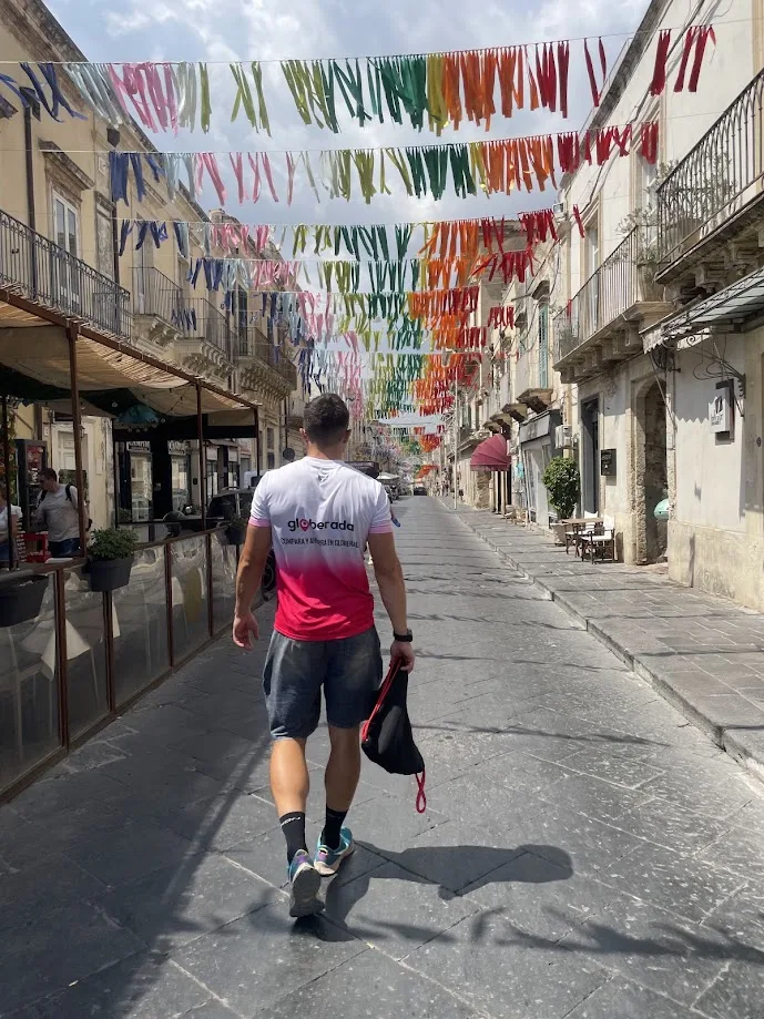 Walking through a decorated street wearing a Globerada shirt