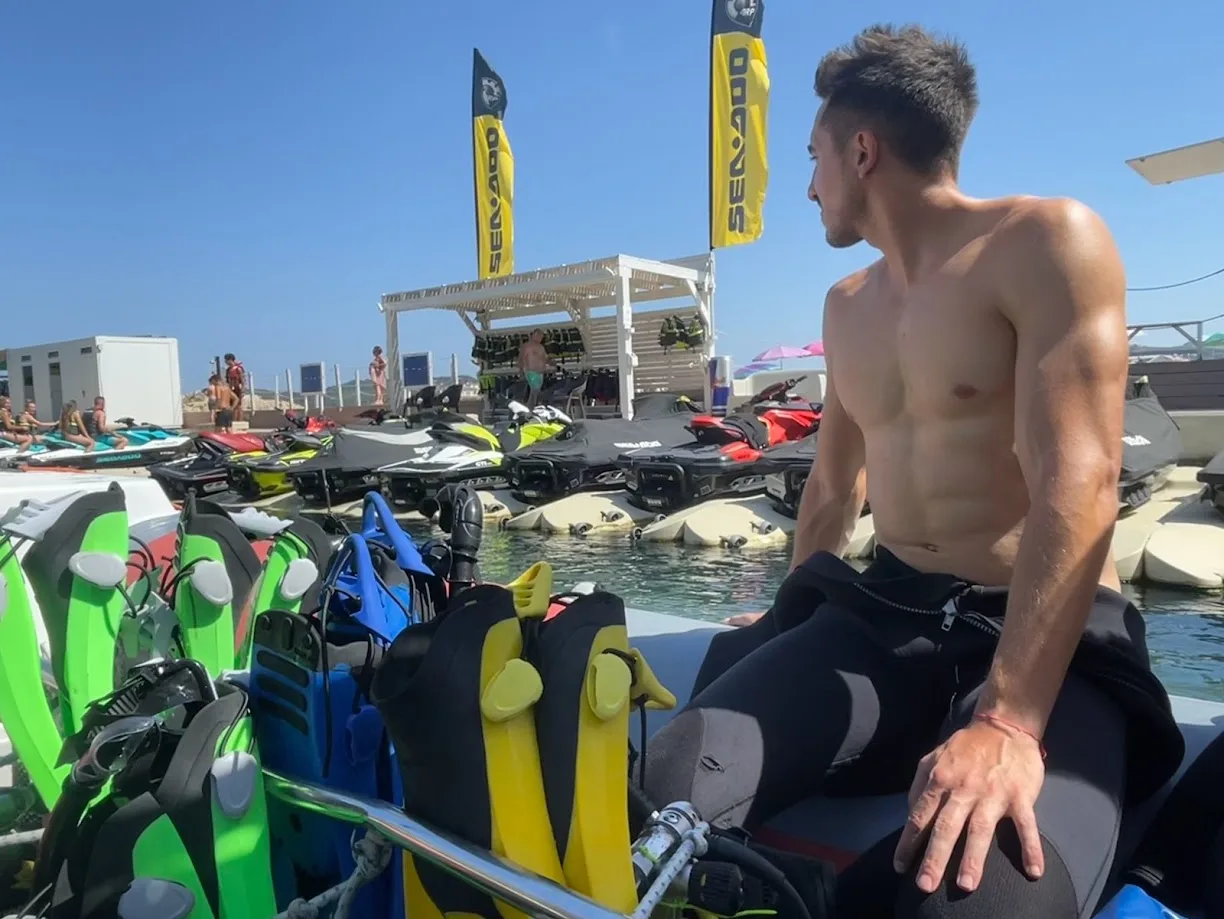 Sitting beside water-sports equipment by the sea